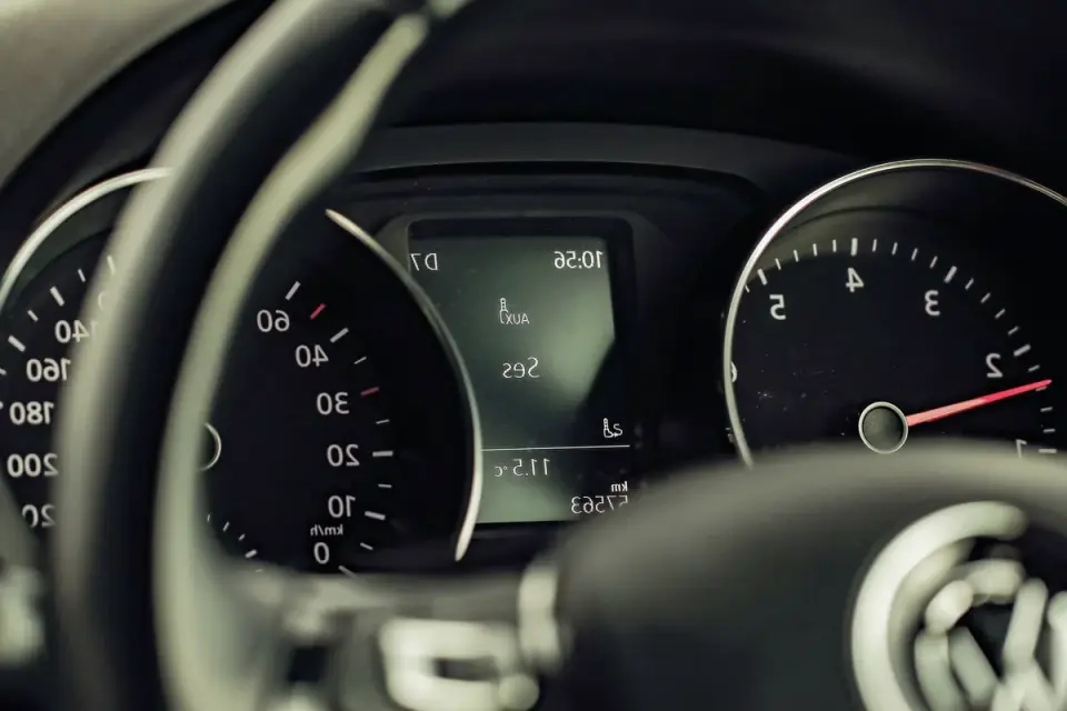 A dashboard thermometer showing a high reading inside a parked car