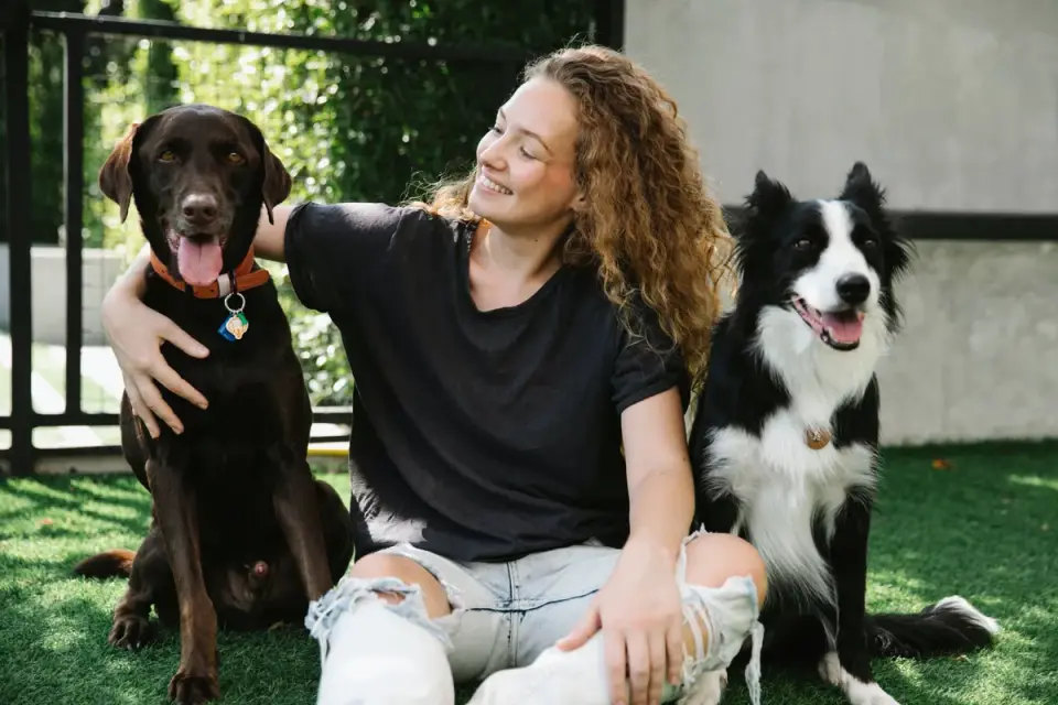 A dog owner walking a pet sitter through a written care checklist before a trip