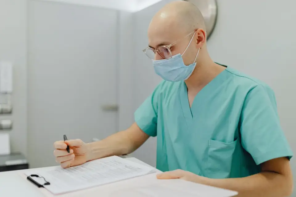 A kennel staff member reviewing a medication log at a boarding facility