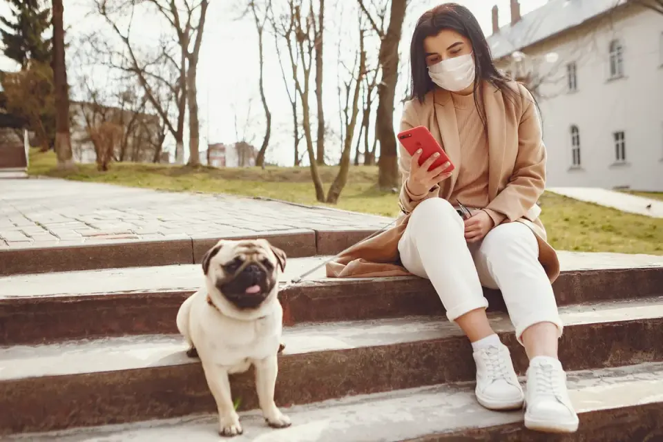 A pet sitter reviewing a printed care sheet beside a leash and food bowl