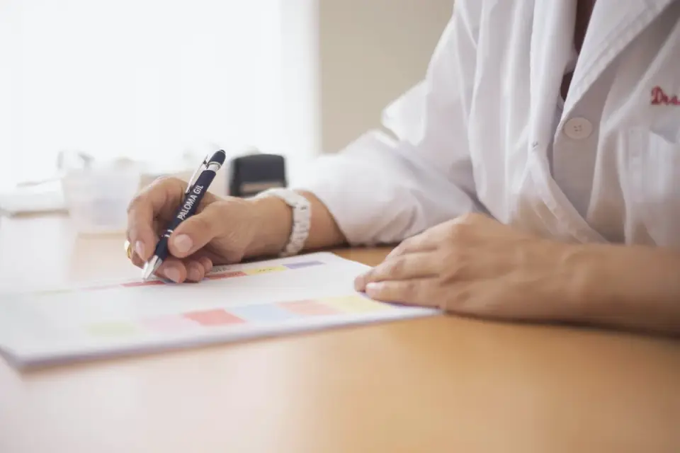 A veterinarian examining a dog with travel health paperwork on the exam table