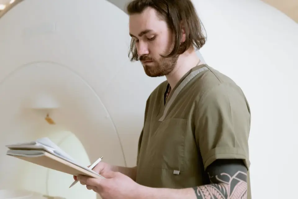 A veterinarian passing a scanner over a dog's shoulders to read a microchip