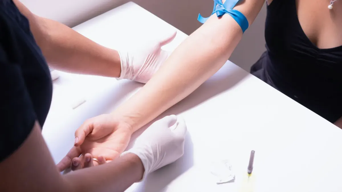 Veterinarian drawing a blood sample from a calm dog on an exam table